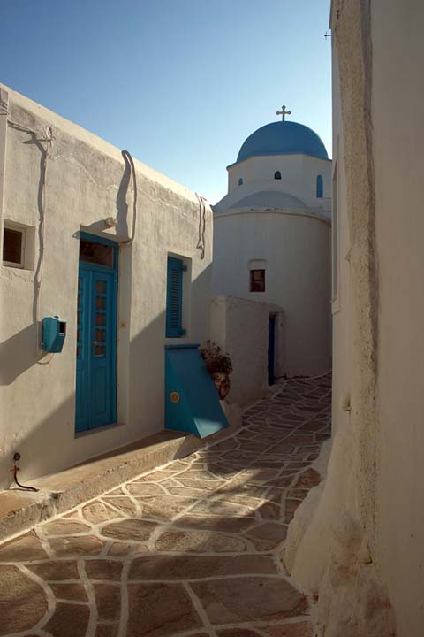 WHITE AND BLUE - A peaceful stroll among the medieval streets of a Greek Island village can lead to chapels like this. I love the afternoon sun, the soft playful light and the shades the buildings create. The chapel can be found on Paros island in a vilage called Lefkes.